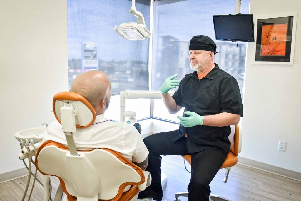 Dr. Alex Pavlenko with Patient | Sana Dental | General & Family Dentist | North Edmonton