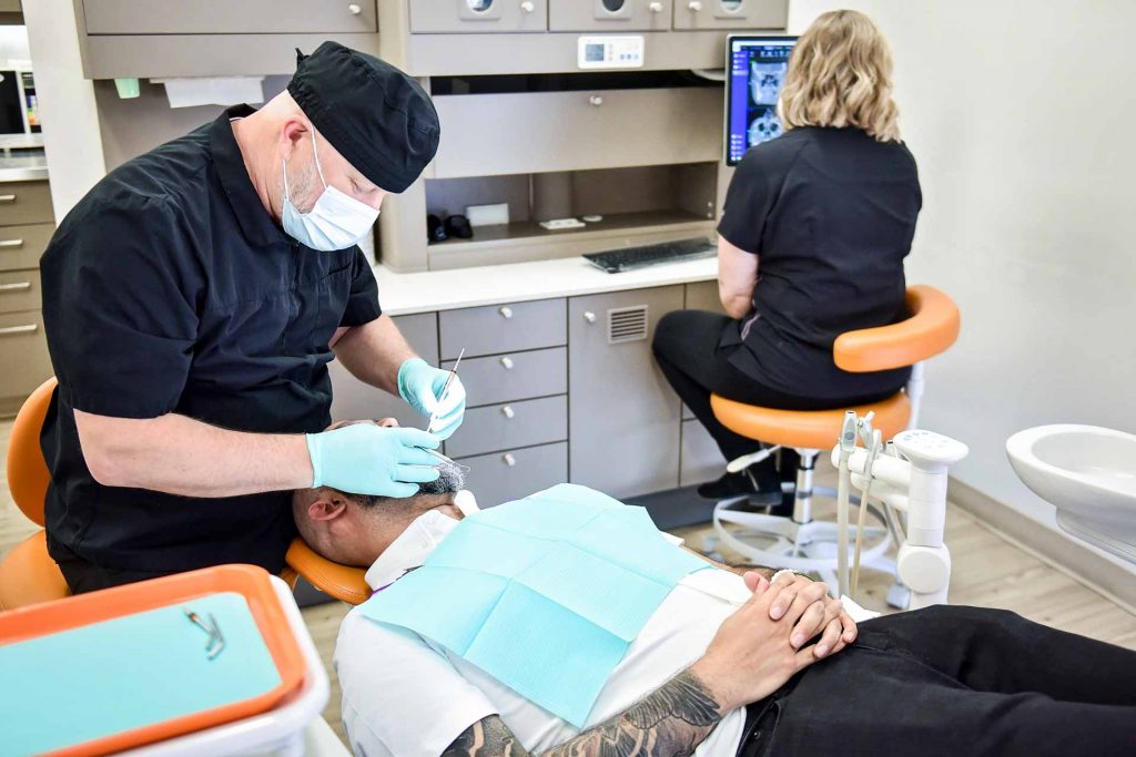 Dr. Alex Pavlenko with Patient | Sana Dental | General & Family Dentist | North Edmonton